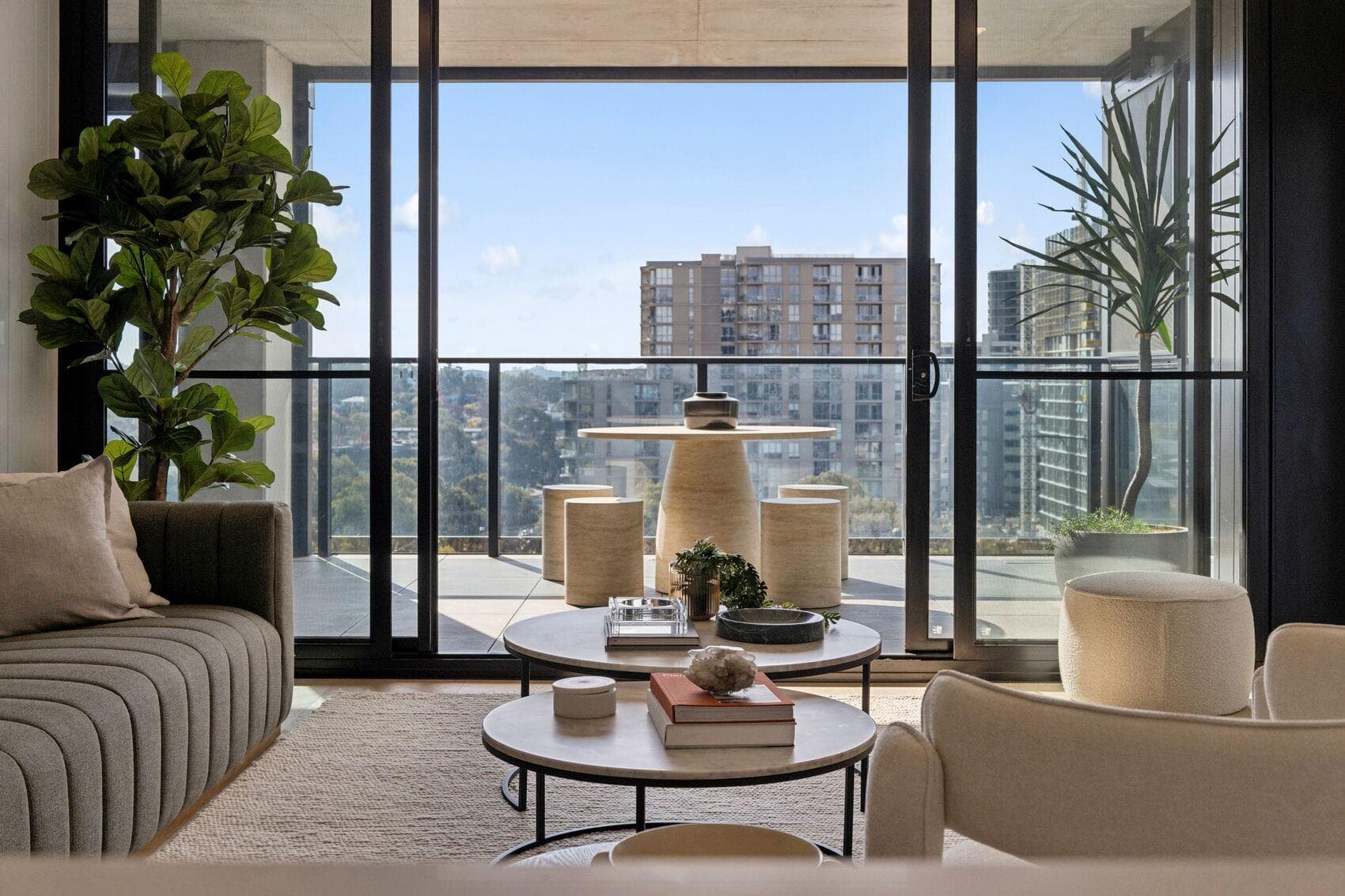 Living area opening onto a balcony with district views